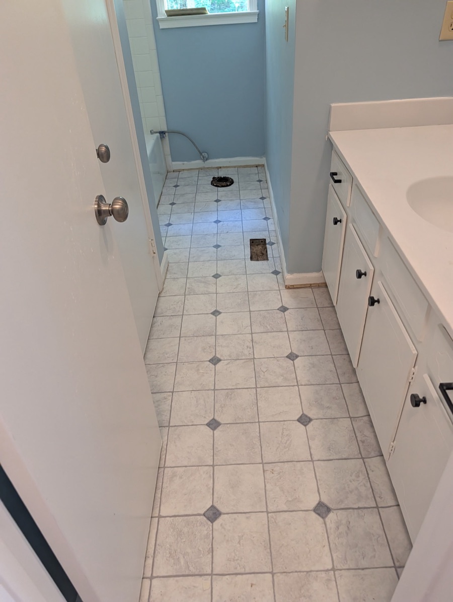The same bathroom with new tile laid, after