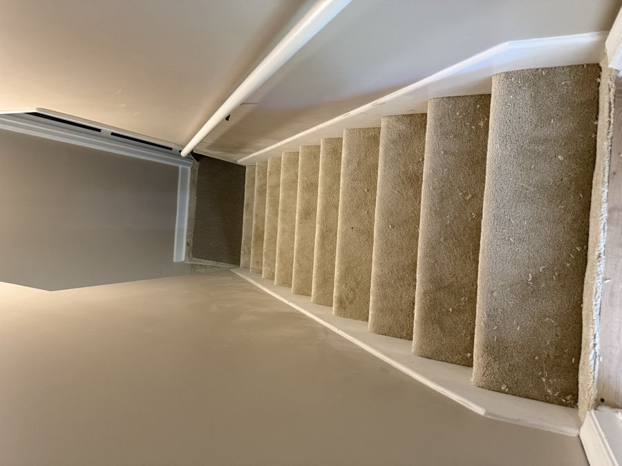 Stairs with worn carpet, before