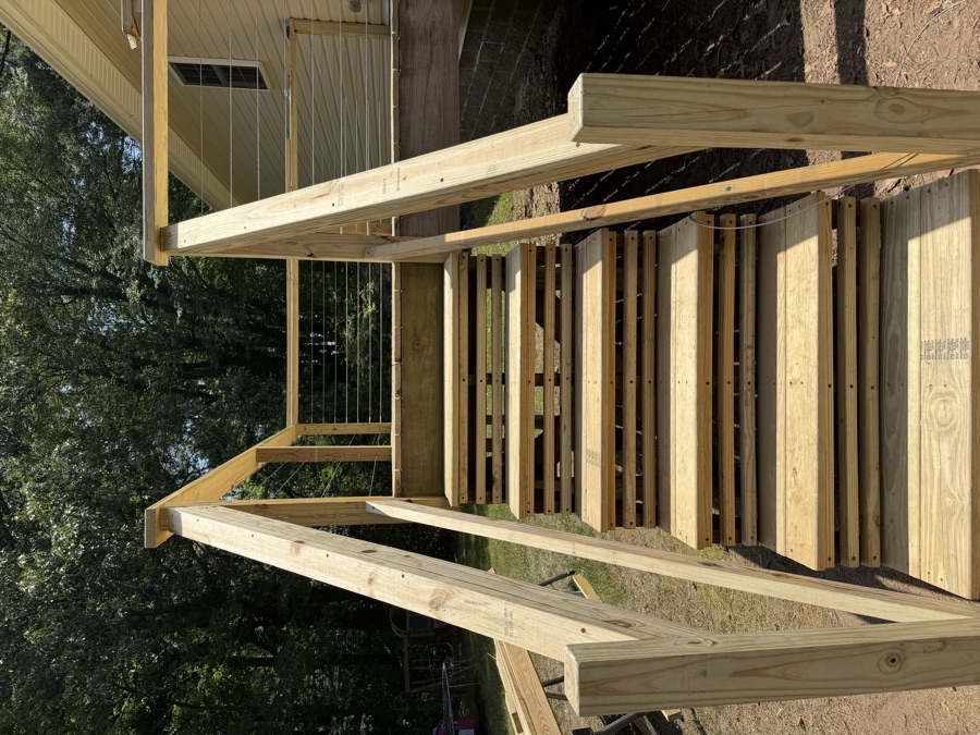 New deck steps and railing in fresh lumber, after