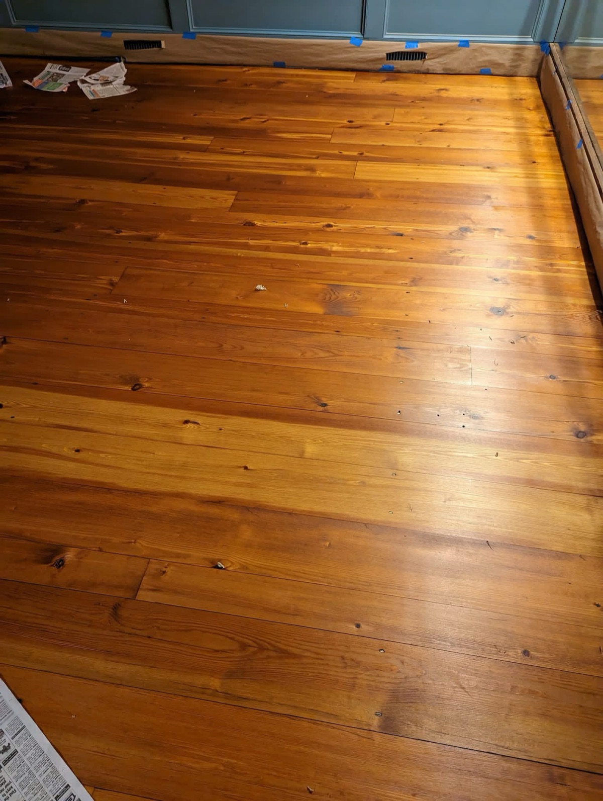 Wide plank flooring with a rich amber finish
