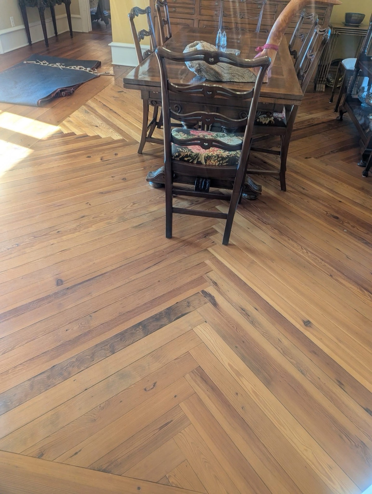 A herringbone hardwood floor in a dining room