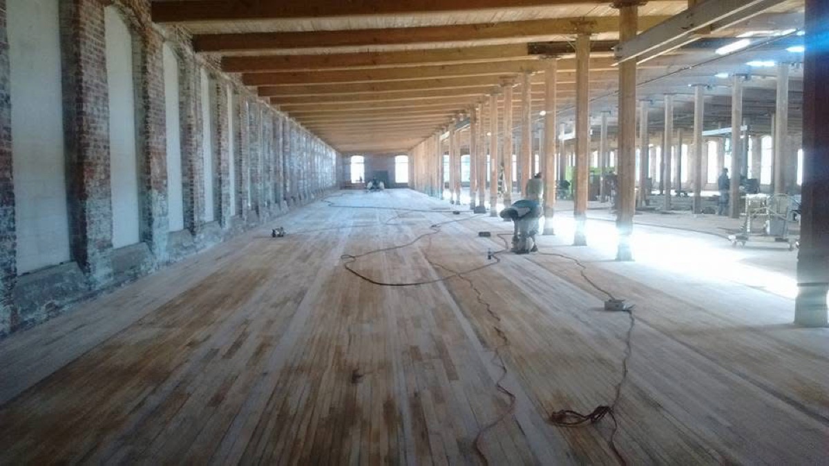 A large floor mid-sand, half raw wood and half old finish